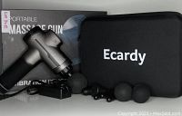 Portable Ecardy massage gun with five attachment heads, charging cable, carrying case, and original box.