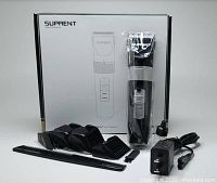 Photo showing Suprent electric hair clippers, four comb heads, black comb, cleaning brush, lubricant, and charging cord arranged on a white background with the product box in the background.
