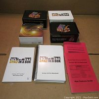 Three boxes of Band in a Box software and one box of Logic Studio, plus manuals for Band in a Box versions 2013, 2016, 2017.