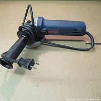 Full view of Bosch angle grinder showing handle, cord and power plug.