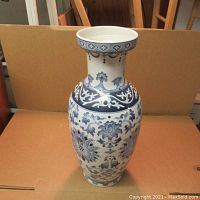 Front view of the vase showing overall shape and blue floral design.