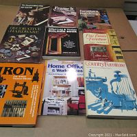 Photo showing nine vintage books arranged inside a box including titles on woodworking, furniture, hardware, and home office.