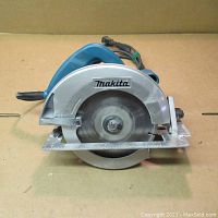 Front view of the Makita 5007F circular saw showing blade and guard with Makita logo.