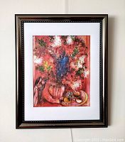 Framed lithograph artwork depicting a bouquet of flowers with fruit and a figure, signed by Marc Chagall.