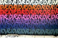 Cropped detail of upper rows of the “love” motif in white and red.