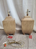 Pair of vintage mid-century lamps with ribbed textured bases and attached electrical cords, original Red Goldcoaster tags visible.