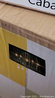 Partial view of the box with printed image of the lamp lighting effect and part of product details.