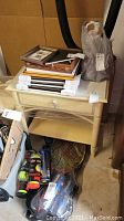 Full view of side table with one drawer, some items on top and below (not included)