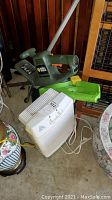Black & Decker hedge trimmer and Family Care air purifier shown together on floor next to furniture