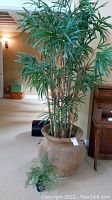 Faux palm tree approximately 80 inches tall placed in a large ceramic pot with a piano and room background.