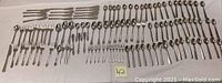 Full layout of flatware showing all forks, spoons, knives and specialty pieces in various patterns.