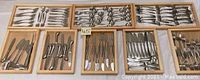 Seven wooden trays arranged showing full assortment of flatware pieces