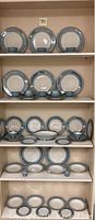 Shelf display showing plates, cups and saucers