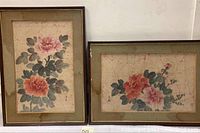 Pair of framed Japanese embroidery artworks on silk showing floral designs of peonies with water stains on the matting.