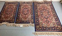 Three Karastan Heriz style runner rugs laid side by side showing their overall appearance, size, and fringed edges.