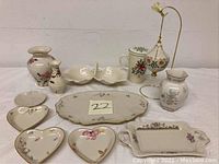 Full lot of Lenox porcelain items including vases, dishes, mug, trays and ornament in floral patterns and gold trim.