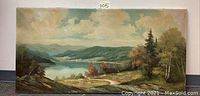 Full view of landscape oil painting showing lake, hills, trees, and sky.