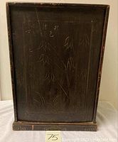 Front view of the altar shrine cabinet showing the engraved bamboo design and Chinese characters on the sliding door.