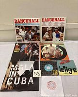 Lot arranged showing all seven records including two Dancehall LPs, four other LPs, and two 7" singles.