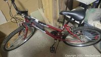 Full side view of the red Supercycle SC1800 ladies bike showing the frame, wheels, and brakes.