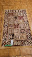 Full view of the rectangular area rug showing overall patchwork design with multiple colored blocks and floral motifs.
