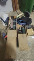 Overview of the two wooden toolboxes containing the assorted tools including grinder and sanders