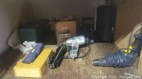 Overview photo of tools showing the air nailer, yellow tool box, box of nails, and black drill.
