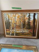 Framed oil painting of autumn landscape with birch trees beside a river, measuring 38 x 22.5 inches