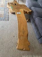Top view of a rustic solid wood coffee table with visible unique grains, knots, and natural edges.