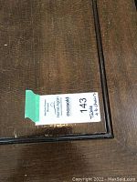 Close-up of table surface with lot tag showing 'Table + 6 Chairs'