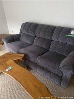 Front view of blue and brown upholstered reclining couch