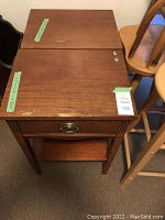 Photo showing two wooden bedside tables side by side with drawer and open shelf. Visible scratches and scuffs on surfaces.