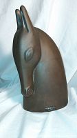 Front angled view of the horse head sculpture showing the elongated ears and detailed eyes, with visible signature by Annette Edmark at the base front.