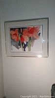 Framed watercolor artwork of red and orange amaryllis flowers with some abstract elements on paper.