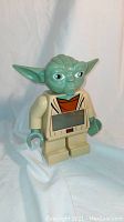 Front view of the Lego Star Wars Yoda digital alarm clock showing the figure's detailed face and the digital display on the torso.