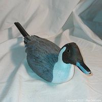 Front view of the hand carved and painted wooden pintail duck decoy showing detailed carving and coloration