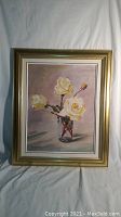 Full view of framed oil painting showing gold wooden frame with linen liner and white roses in glass vase.