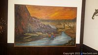 Frontal view of the oil painting on board showing the miner, river, rocky cliff and sunset.