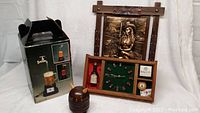 Showing Las Vegas themed clock, boxed beer jug light fountain, 3D farmer art, and Viking style coasters
