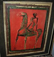 Straight-on view of framed 'Le Cavalier' lithograph by Marino Marini, red background horse and rider, gold frame and black linen mat