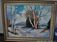 Frontal view of the signed winter landscape oil painting depicting birch trees, snow, pathway, and mountains with a wood frame.