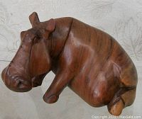 Front side view showing detailed facial features and wood grain texture.