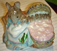 Multiple angles of a Beswick ceramic figurine showing Hunca Munca with a basket of mice. The figurine is painted with pastel colors and detailed facial features, measured at 2.5 inches tall.