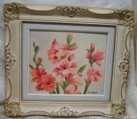 Front view of floral still life painting in ornate cream frame showing pink and red gladiolus flowers on board, signed lower right HLM '71