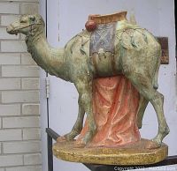 Side view of the large pottery camel statue showing decorative saddle and base