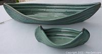 Angle view of both pottery boats showing their shape and size difference