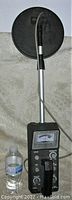 Front view of the metal detector showing the rod, handle, and metal detection disc.