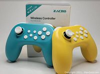 Photo of two wireless Nintendo Switch controllers, one teal blue and one yellow, with included packaging box for the blue controller.