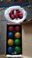 Close-up of bocce balls within the netting inside box showing color and acrylic finish.