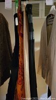 Hanging garments including skirts, a dress, and palazzo pants seen on hangers